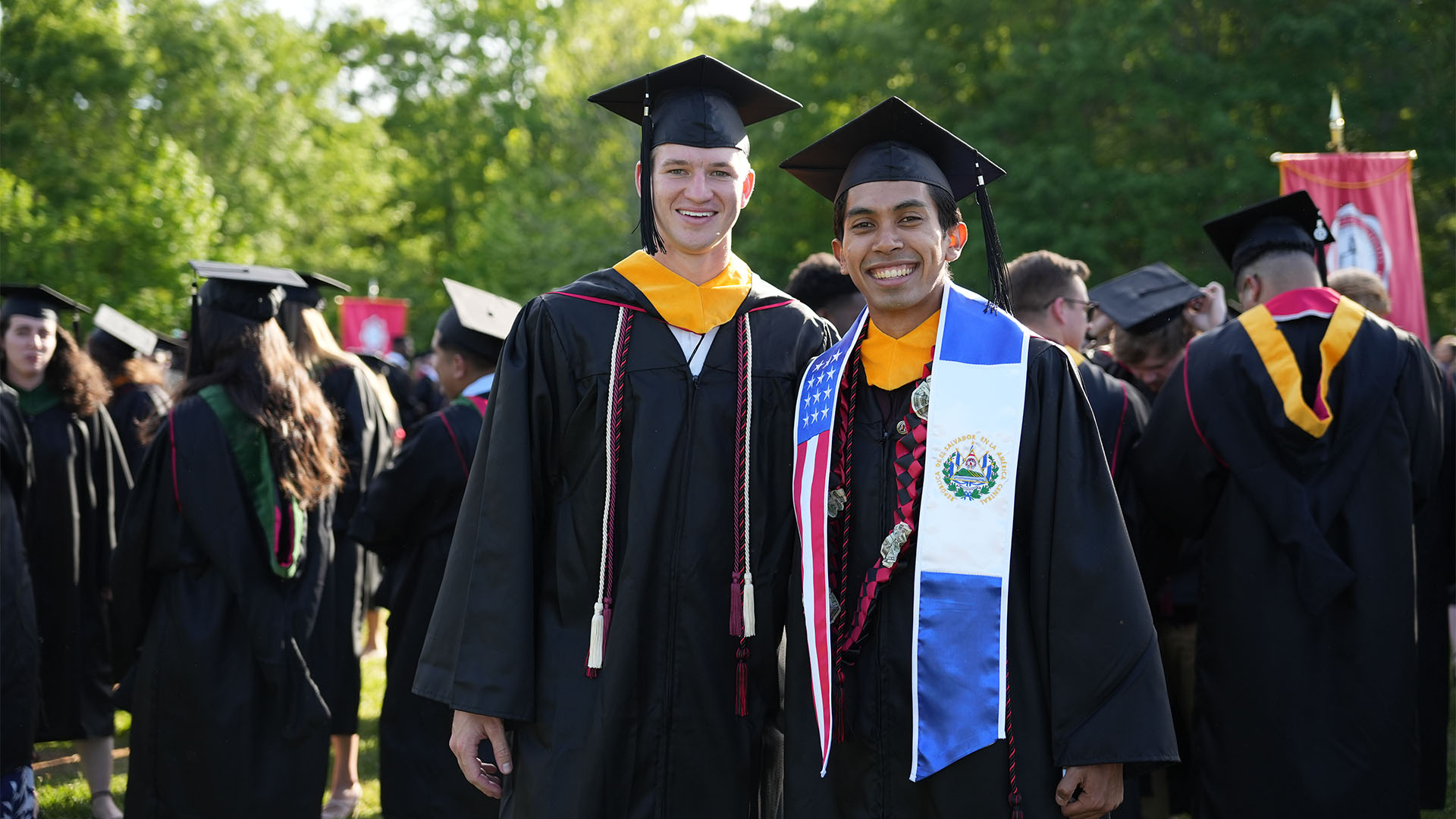 two male students smiling for photo at GWU commencement